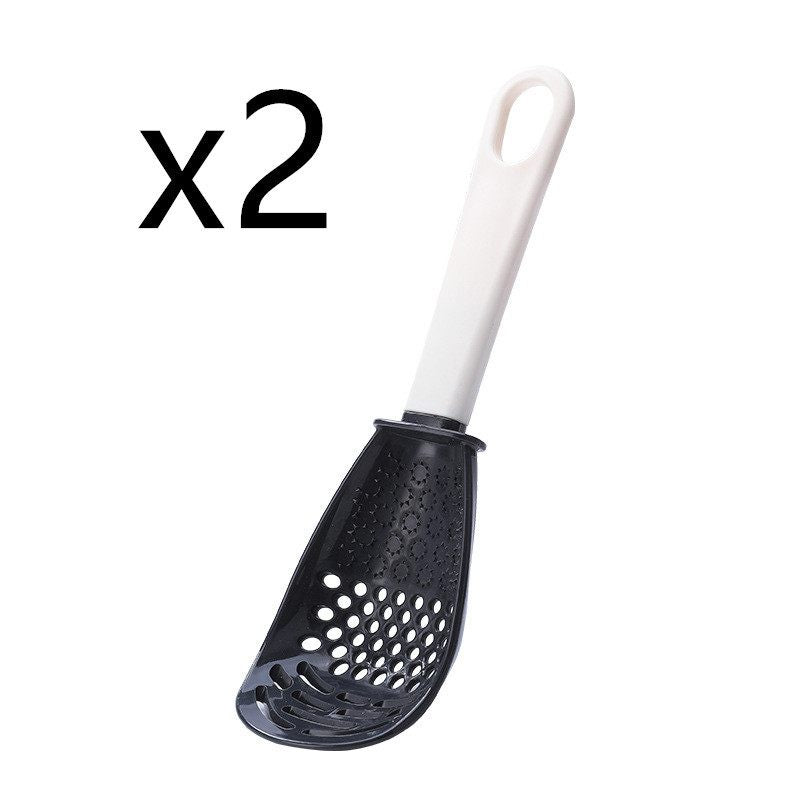 Black kitchen skimmer with white handle on a white background, labeled 'x2'.