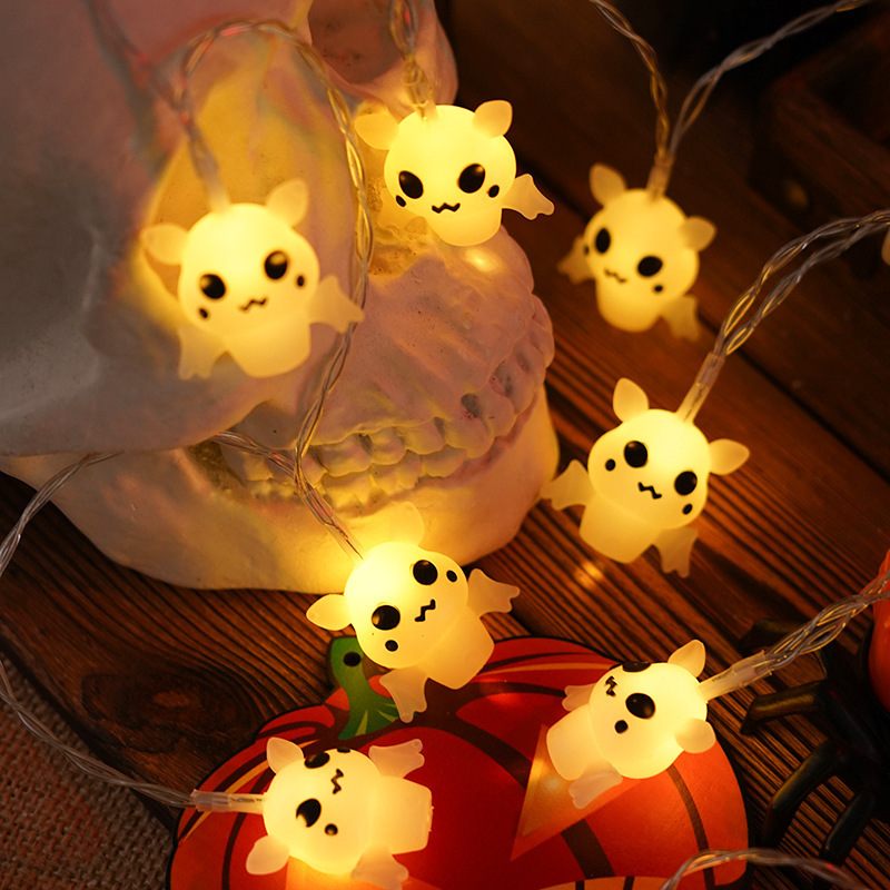 String lights with cartoon ghost characters on a wooden surface.