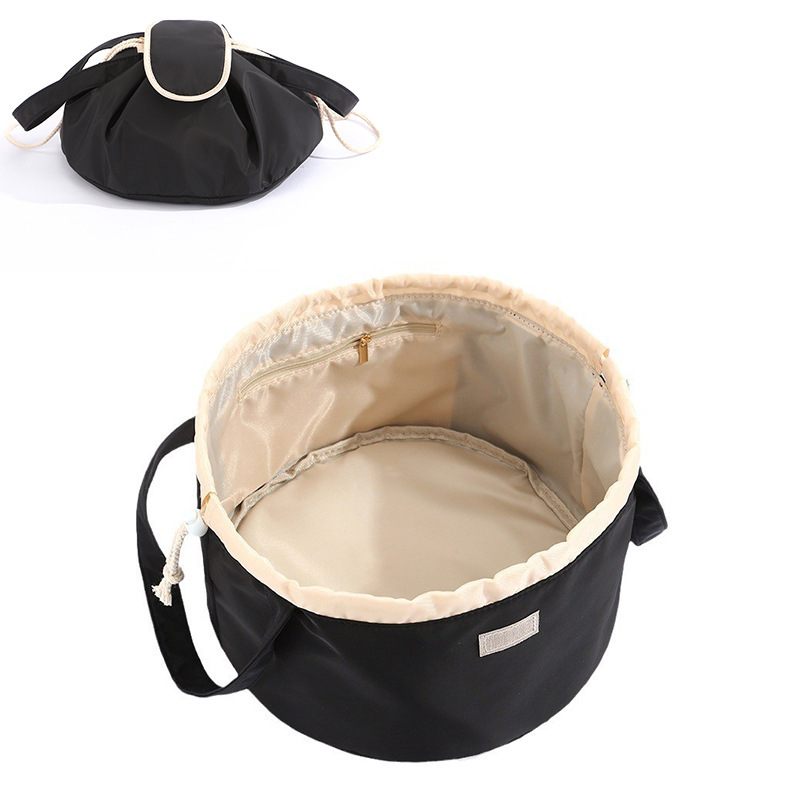 Black drawstring bag with beige interior on a white background