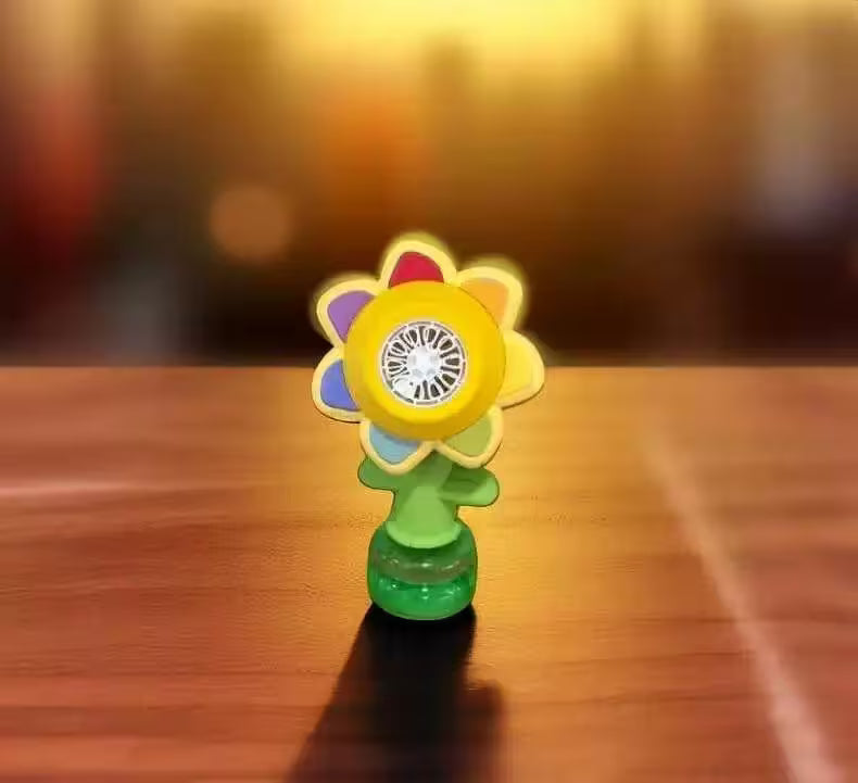 Colorful flower-shaped object on a wooden surface with a blurred background