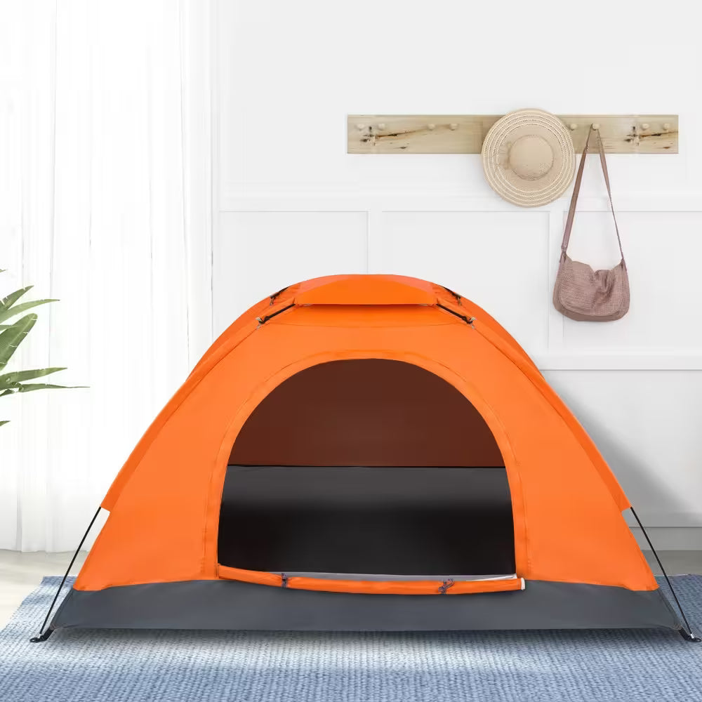 Orange tent on a blue mat with a white wall background