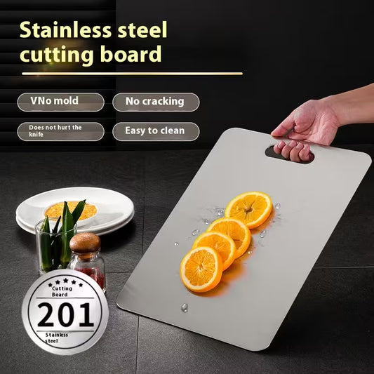 Stainless steel cutting board with sliced oranges on a dark surface