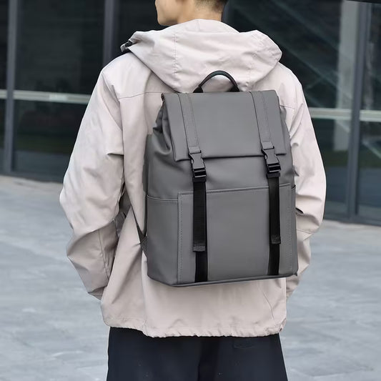 Person wearing a gray backpack with a blurred background