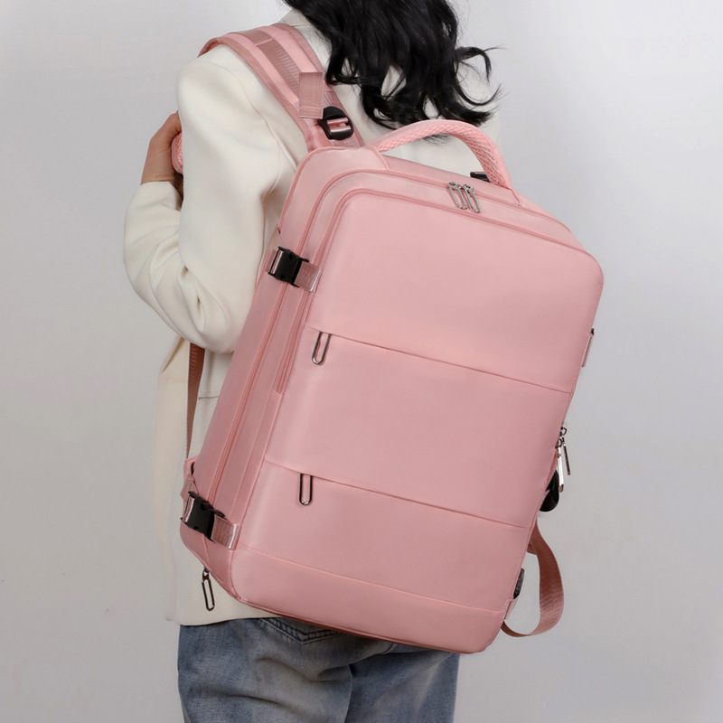Person wearing a pink backpack against a plain background