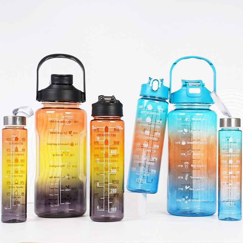 Set of colorful water bottles with measurement markings on a white background