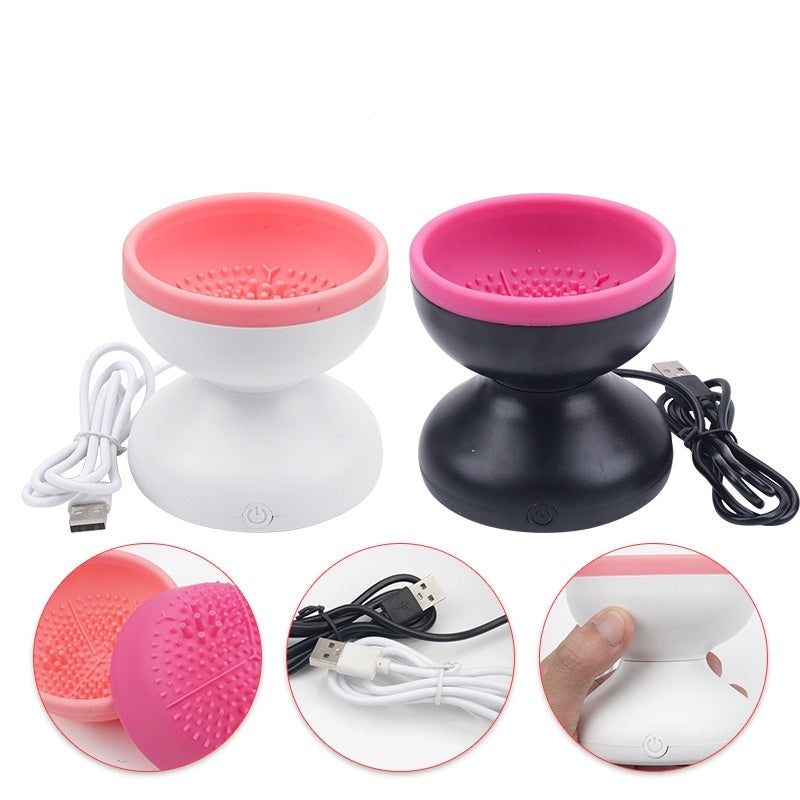 Two silicone massage balls with USB cables on a white background