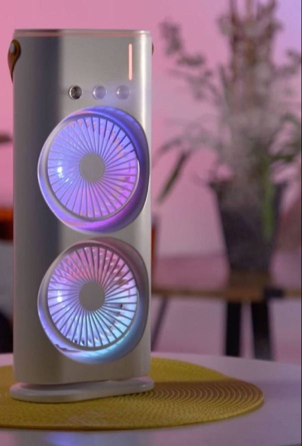 White electronic fan device with colorful circular lights on a blurred background