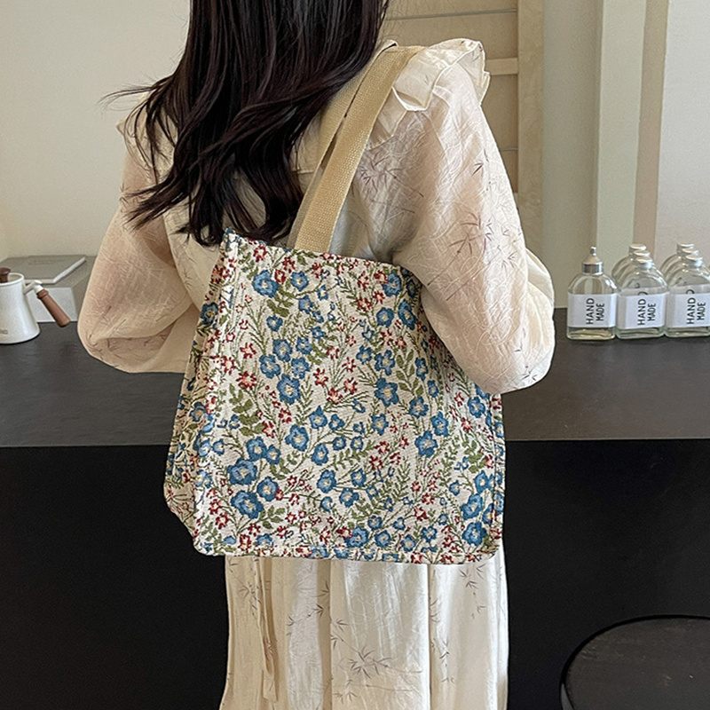 Person wearing a floral-patterned bag in a kitchen setting