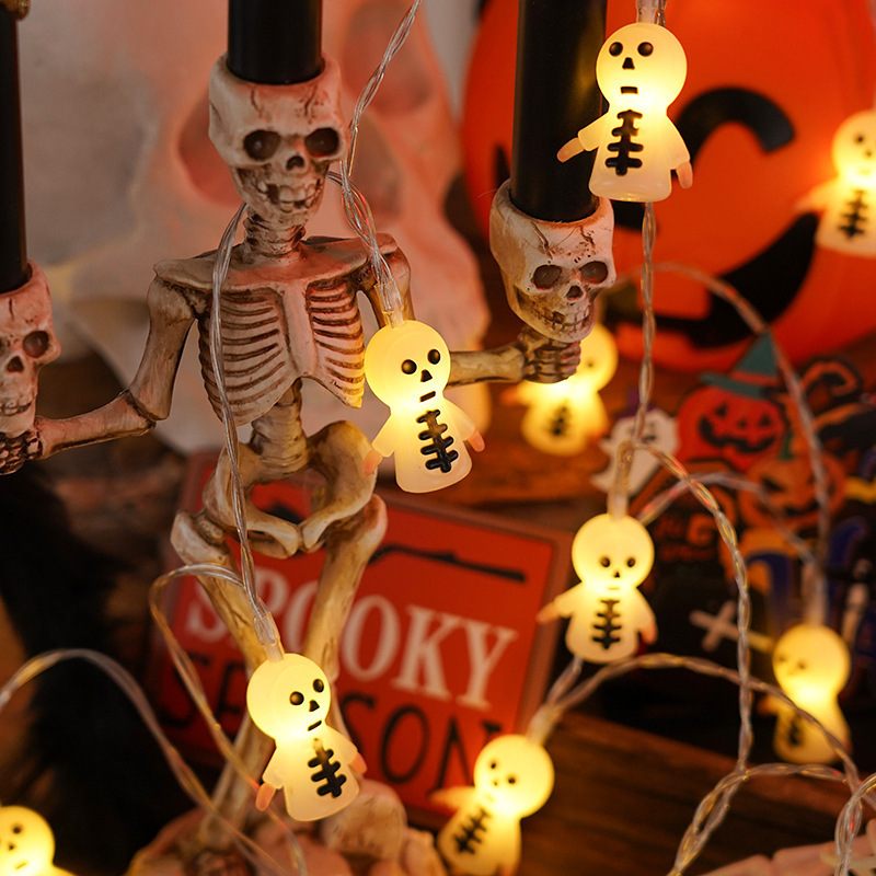 Halloween-themed string lights with skeletons and ghosts on a festive background.