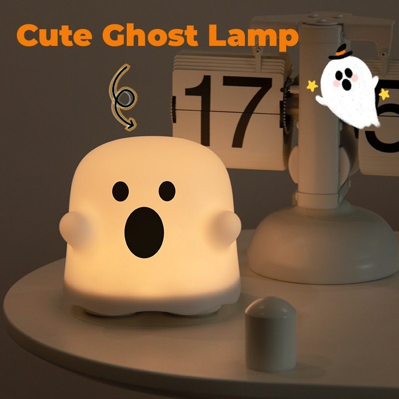 Cute ghost-shaped lamp with a calendar in the background