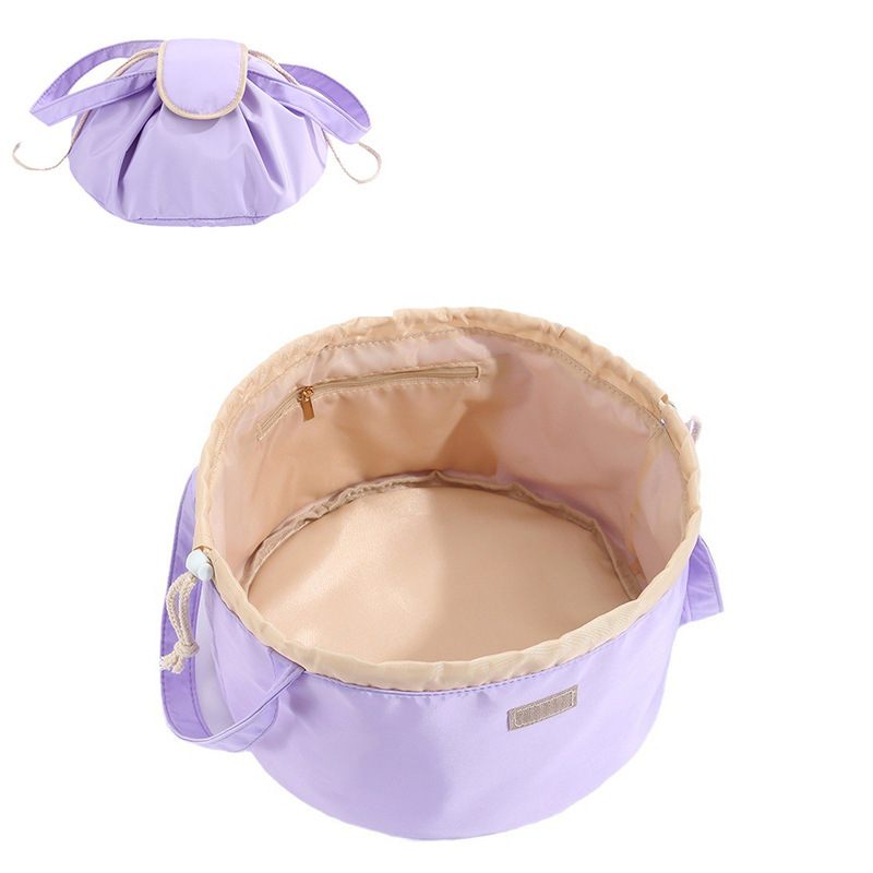 Purple pet bed with beige interior on a white background
