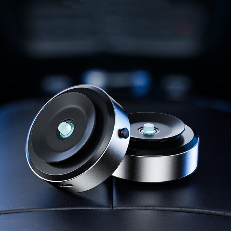 Two metallic circular objects with a glowing center on a dark background