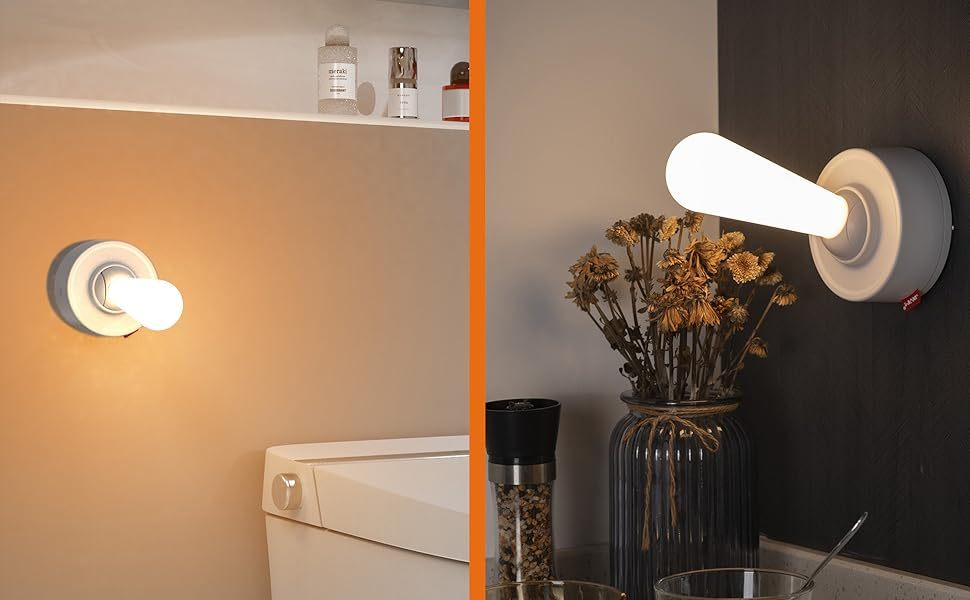 Modern wall-mounted light fixtures in a bathroom setting with a vase of flowers.