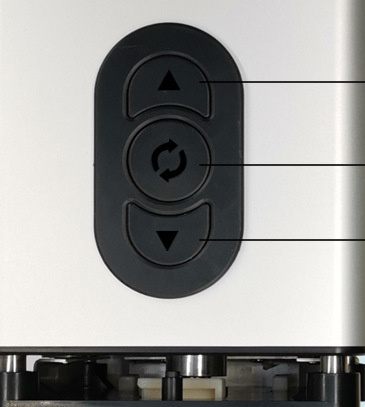 Control panel with directional arrows on a white appliance