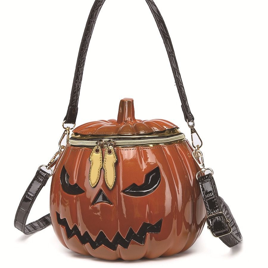 Pumpkin-shaped handbag with a face design on a white background