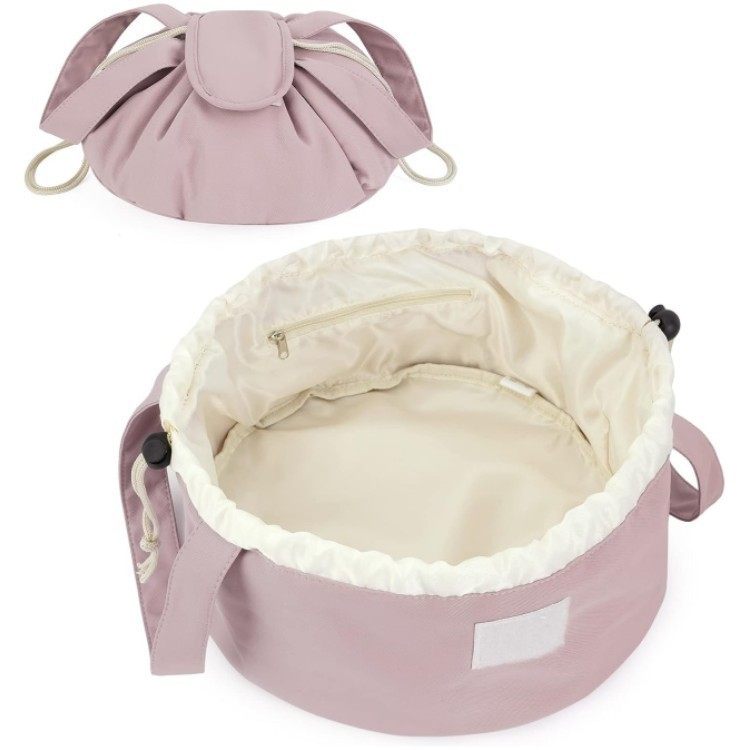Pink drawstring bag with beige interior on a white background