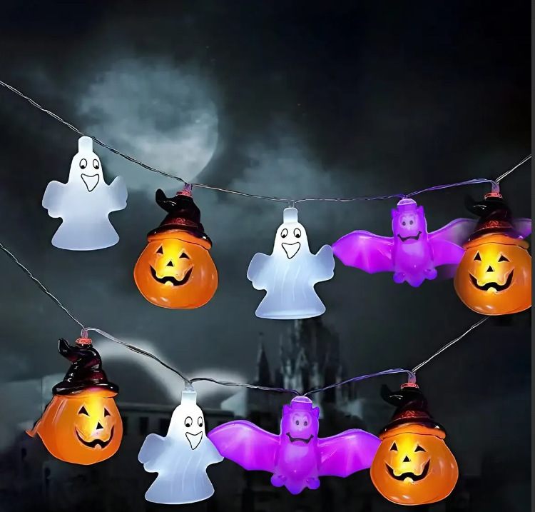 Halloween-themed string lights with ghost, pumpkin, and bat designs against a dark background.