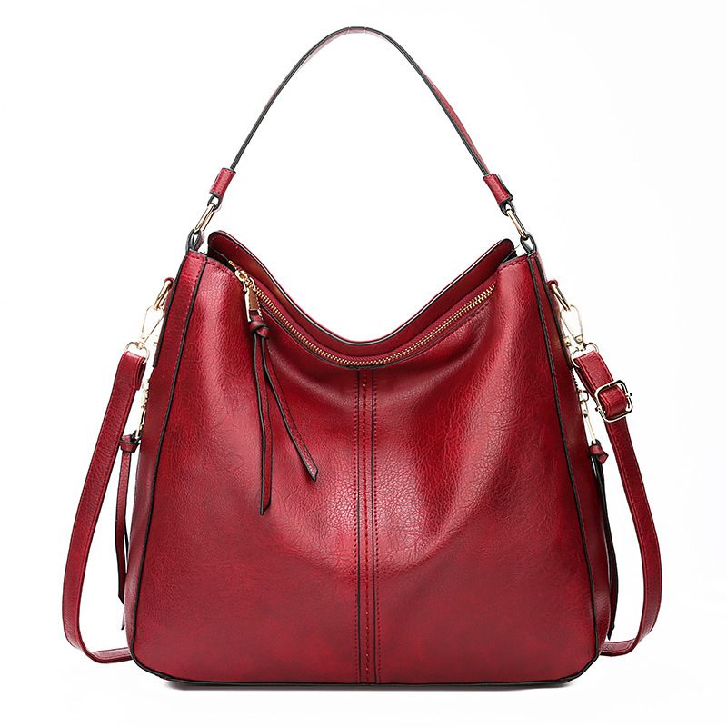 Red handbag with gold accents on a white background