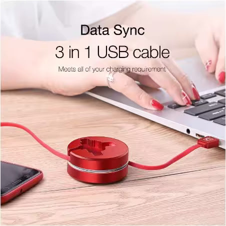 Red 3-in-1 USB cable with a laptop and smartphone on a wooden surface.