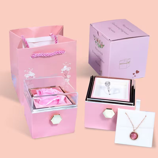 Pink jewelry box with a necklace on a pink background