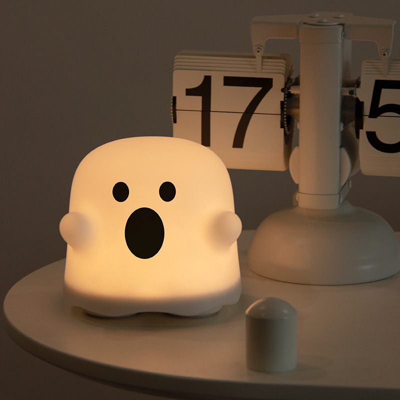 Ghost-shaped night light on a table with a calendar in the background
