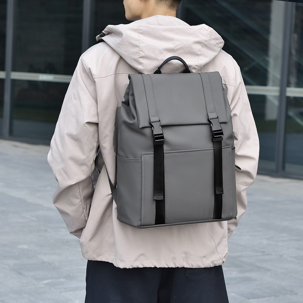 Person wearing a gray backpack outdoors