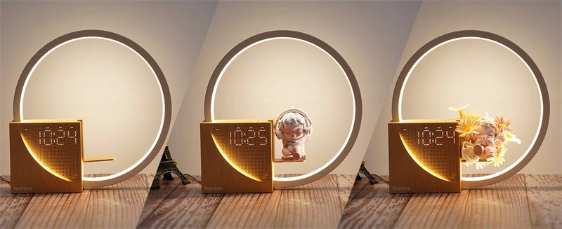 Three decorative items with circular lights on a wooden surface.