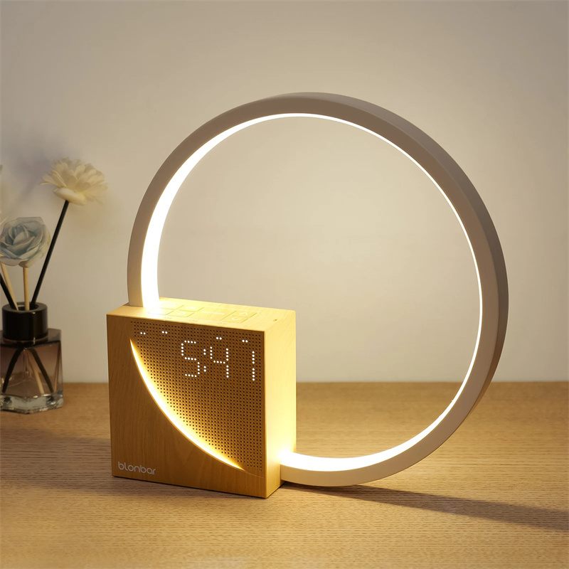 Modern table lamp with digital clock display on a wooden surface