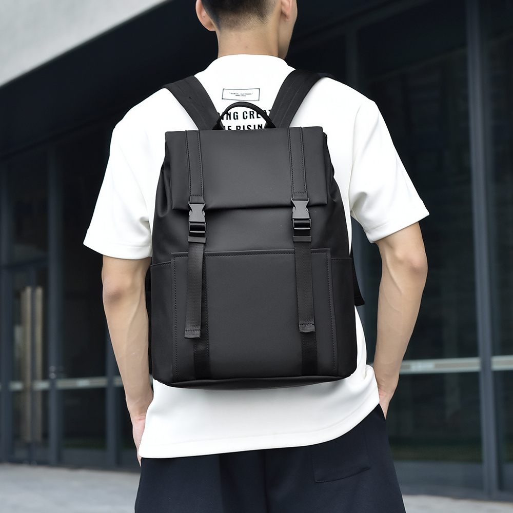 Person wearing a black backpack in an urban setting