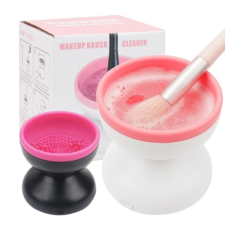 Makeup brush cleaner with pink and black design, including a brush in use.