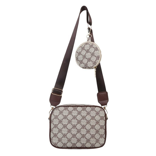 Patterned crossbody bag with matching round keychain on a white background