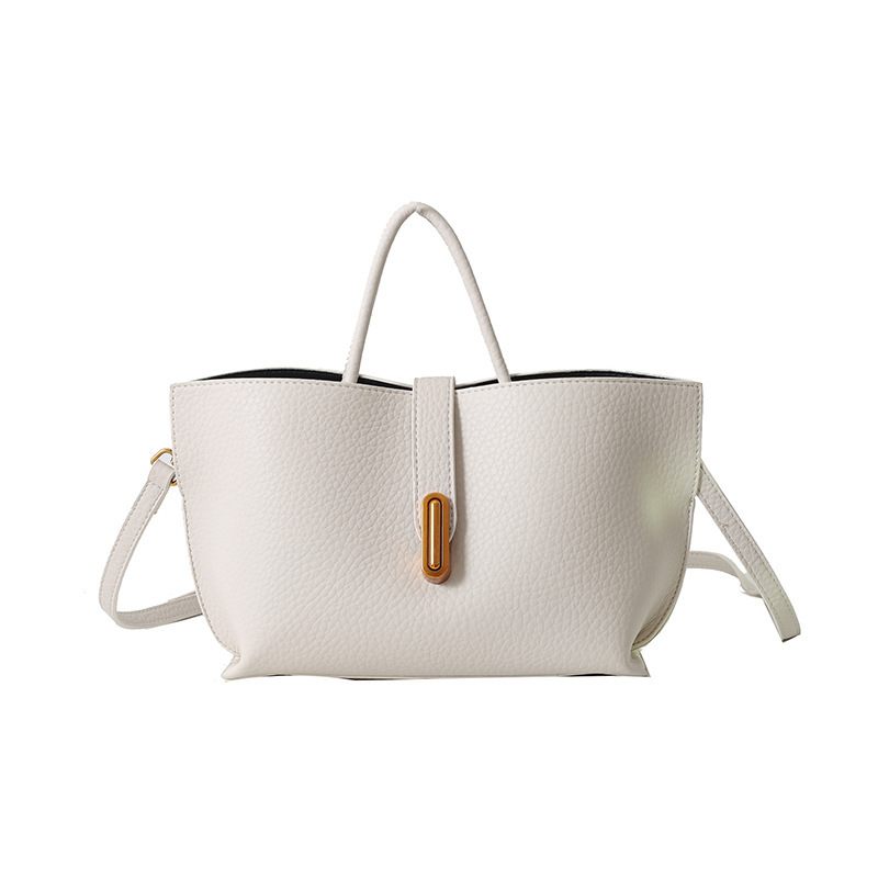 White handbag with a brown buckle on a white background