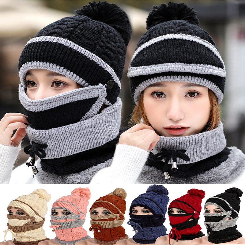Knitted hats and scarves with pom-poms in various colors on a blurred background