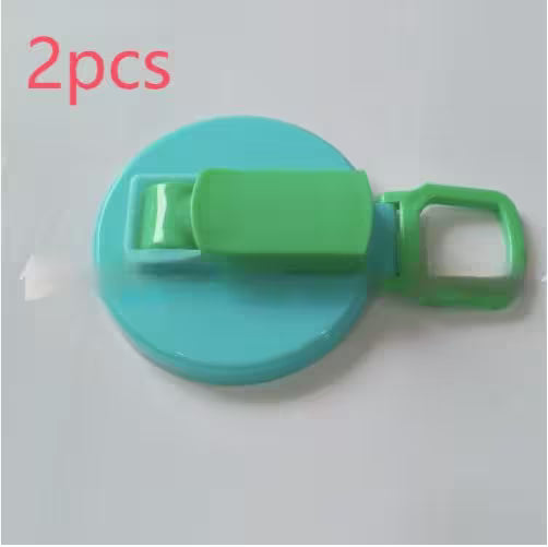 Green and blue plastic clip with '2pcs' text on a light gray background
