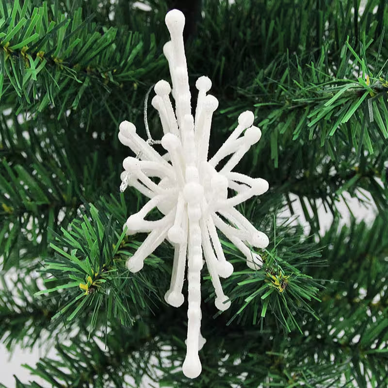 White snowflake ornament on a green Christmas tree