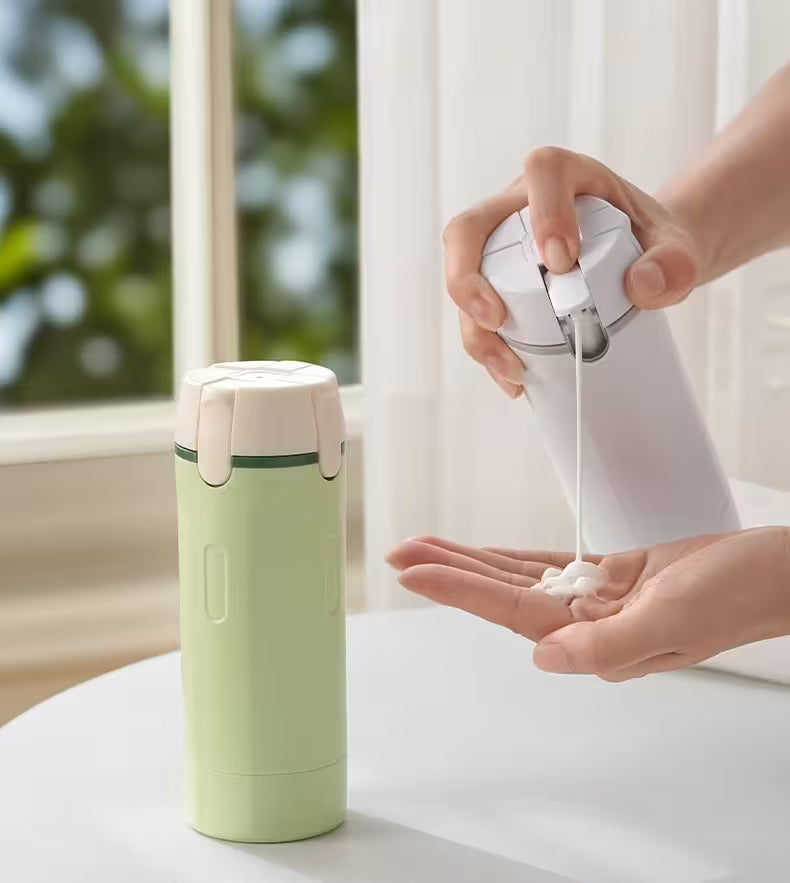 Person using a white hand sanitizer bottle on their palm next to a green and white thermos.