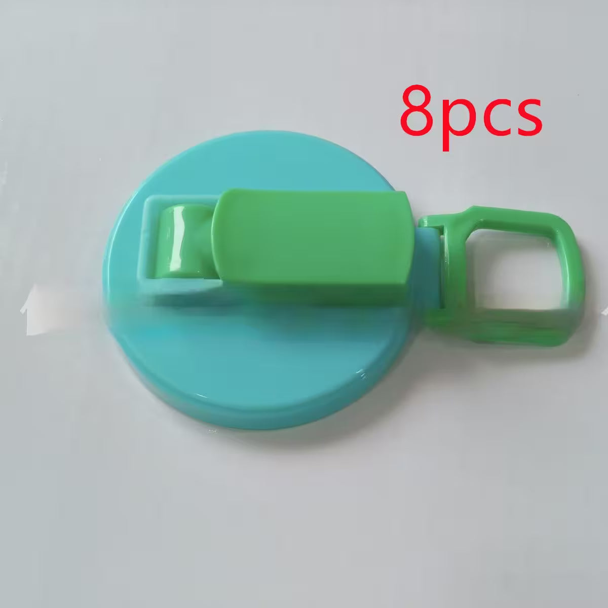 Green and blue plastic clip with '8pcs' text on a white background