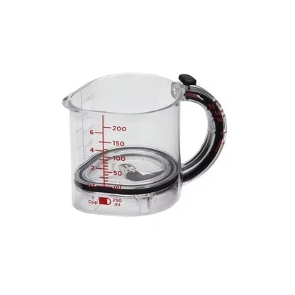 Clear measuring cup with red measurement markings on a white background