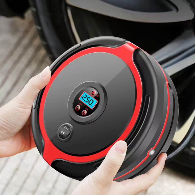 Hand holding a black and red portable air compressor with digital display