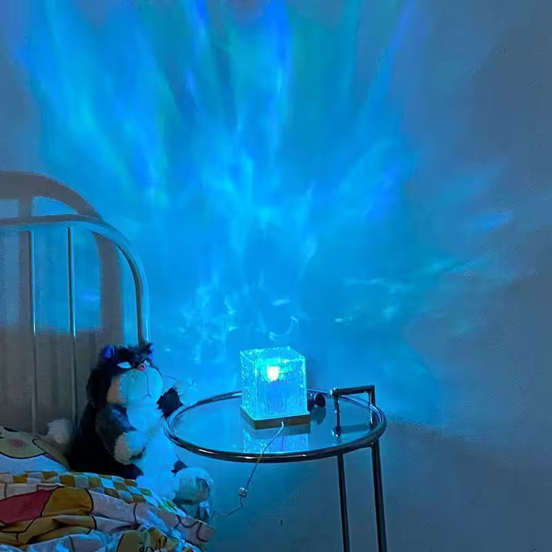 Room with a night light projecting a blue light onto the wall, next to a bed with a plush toy.