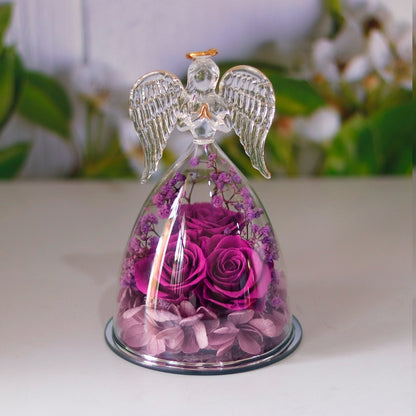 Angel statue made of clear glass with golden outline drawing wings, halo and folded palms.