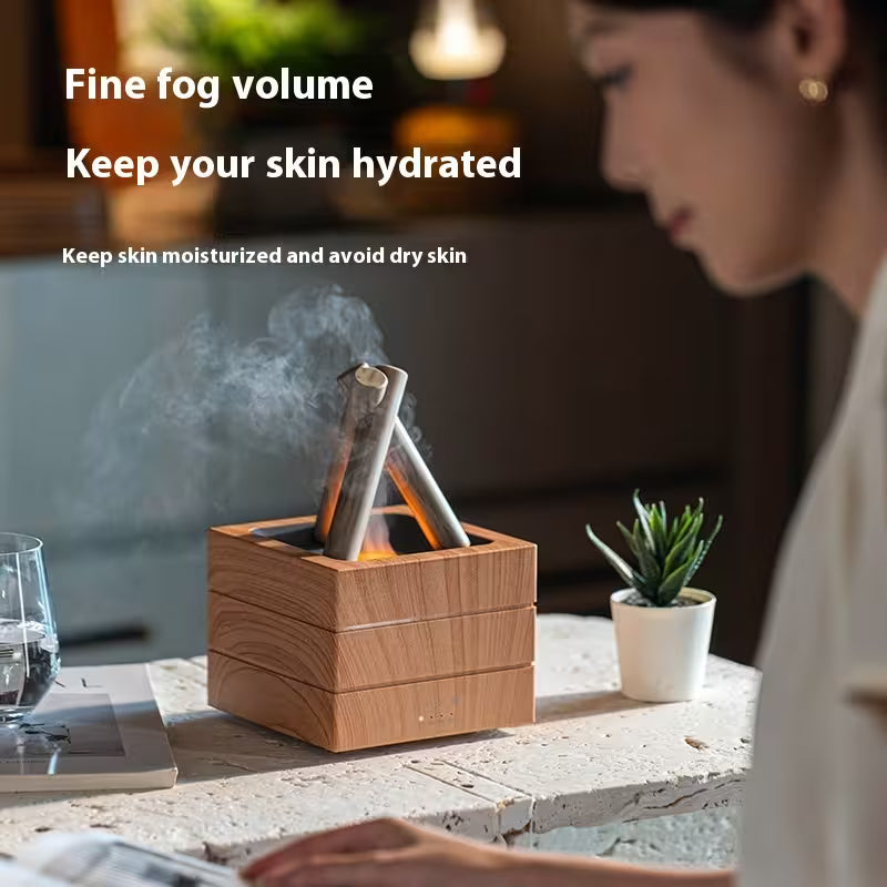 Wooden diffuser emitting mist on a table with a blurred person and plant in the background