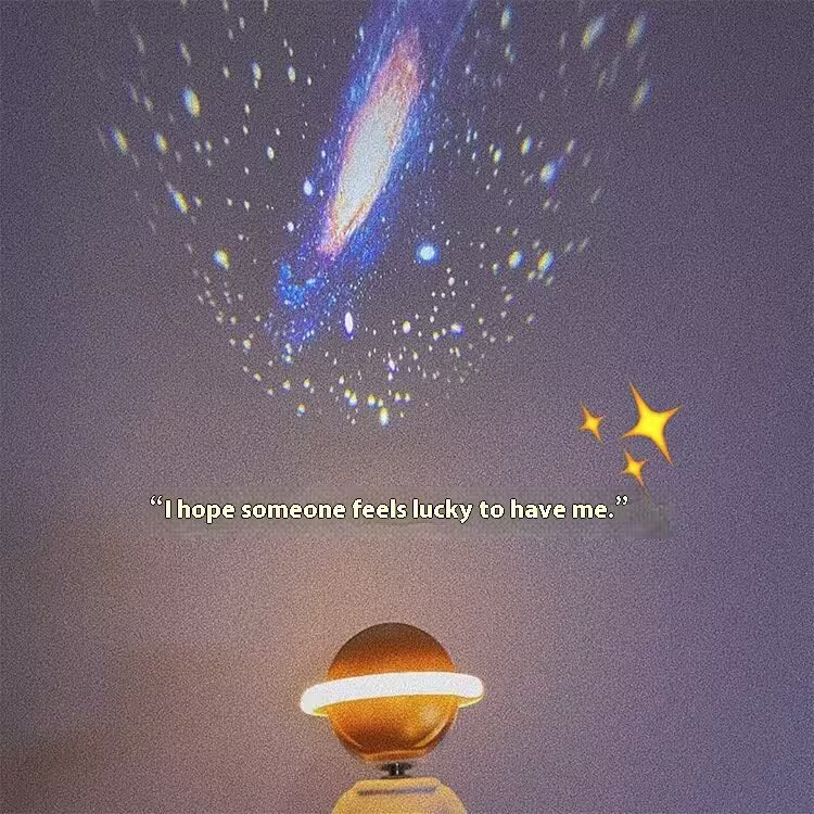 Decorative lamp shaped like a planet with a comet and stars in the background, featuring a quote.