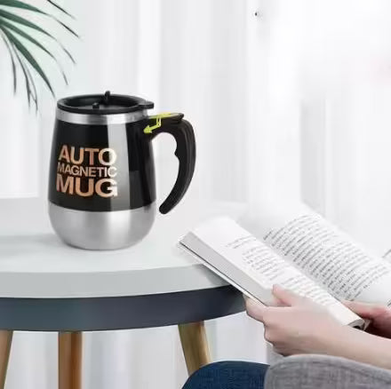 Auto magnetic mug on a table with a person reading a book in the background