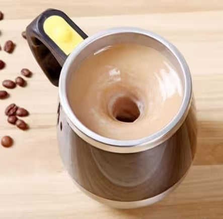 Coffee grinder with coffee beans on a wooden surface
