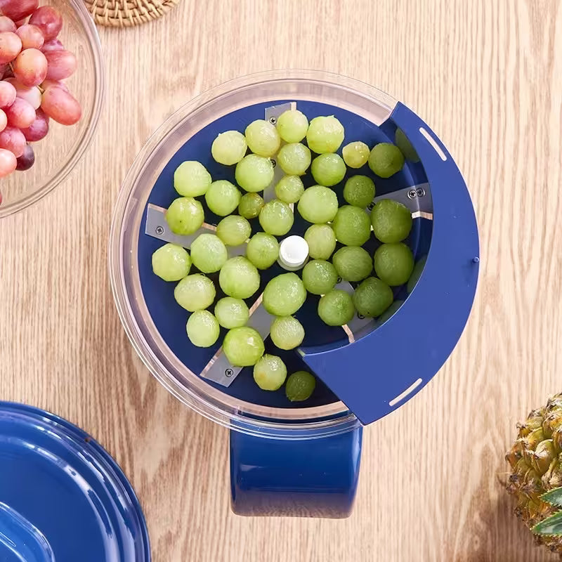 Blue grape slicer with green grapes on a wooden surface