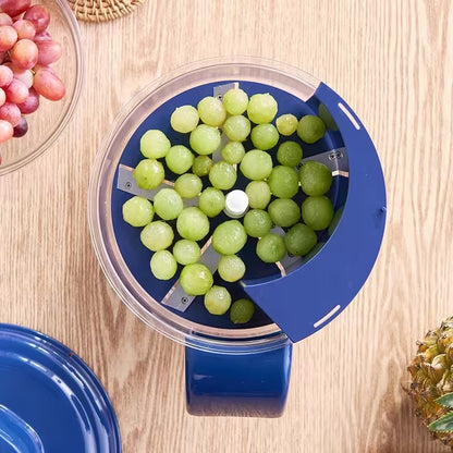 Blue grape slicer with green grapes on a wooden surface