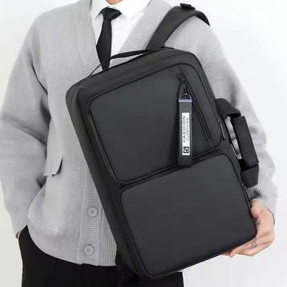 Person wearing a black crossbody bag with a visible brand label on a white background