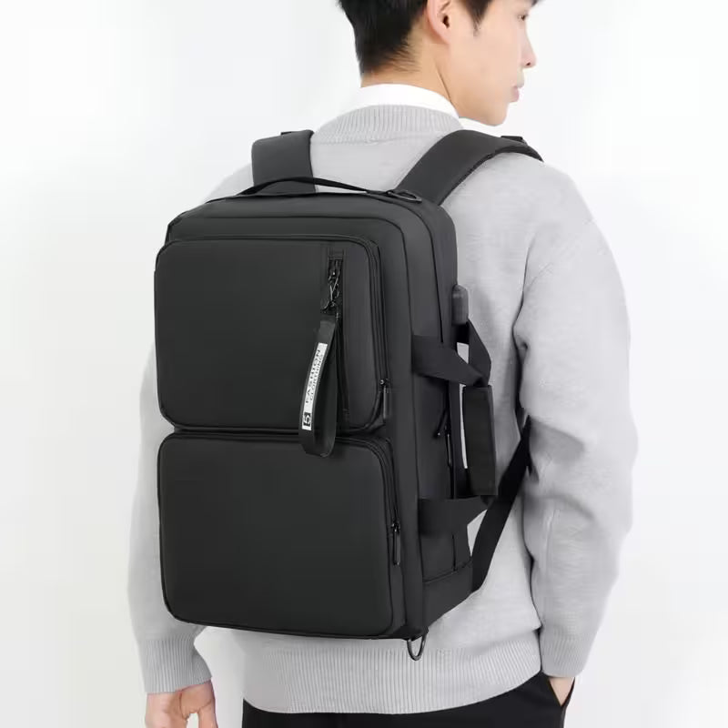 Person wearing a black backpack on a white background