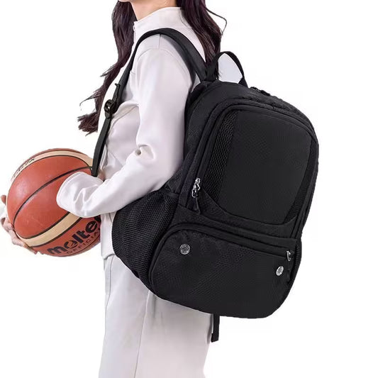 Person wearing a black backpack holding a basketball on a white background